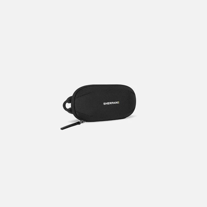A Sherpani Mini Co-Pilot Carbon Black Mini Travel Organizer, 3/4 view showing main zipper and side handle on white background.  #color_carbon-black