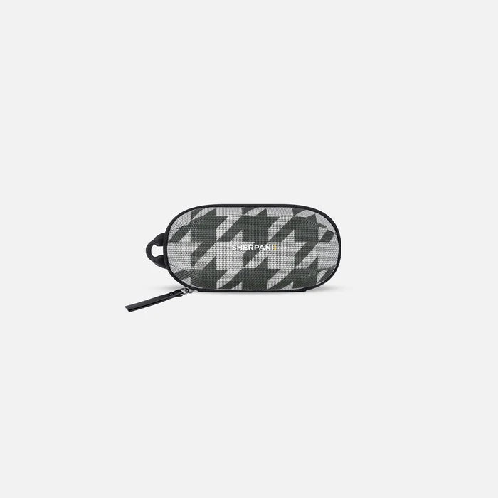 A Sherpani Mini Co-Pilot Houndstooth Mini Travel Organizer, front view showing side handle and main zipper against white background. #color_houndstooth-print