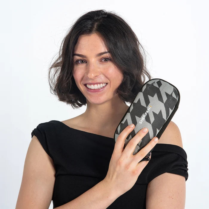 Woman holding a Sherpani Mini Co-Pilot Houndstooth Mini Travel Organizer against white backdrop. #color_houndstooth-print