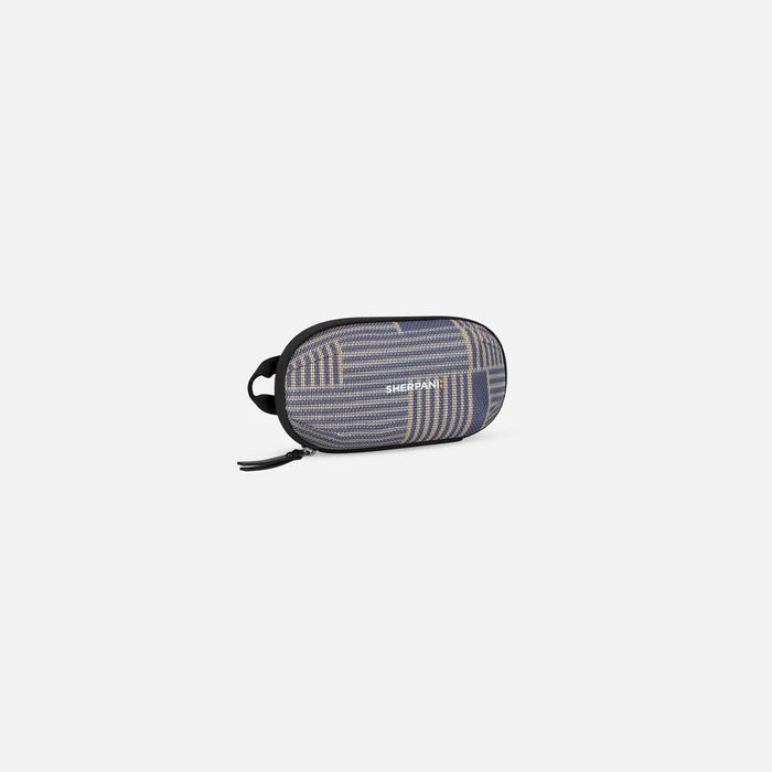 A Sherpani Mini Co-Pilot Passport Mini Travel Organizer, 3/4 view showing main zipper and side handle on white background.  #color_passport-print