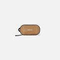 A Sherpani Mini Co-Pilot Sand Mini Travel Organizer, front view showing side handle and main zipper against white background. #color_sand-tan