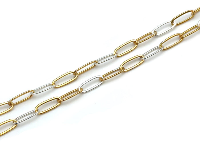 A two-tone paperclip chain necklace featuring alternating gold and silver oval links, displayed diagonally on a clean white background.