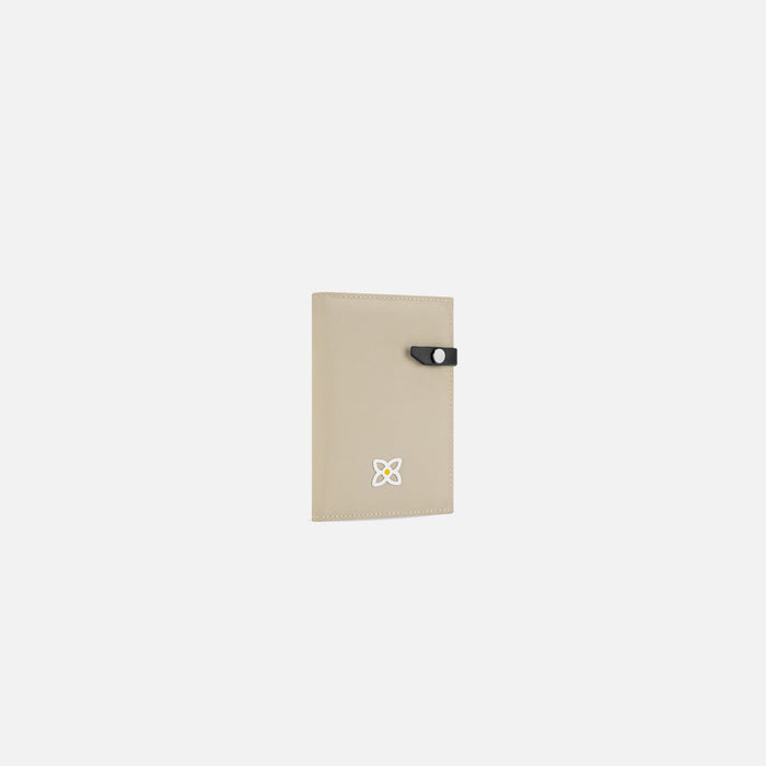 A Sherpani Osaka Moab Passport Holder, 3/4 view showing clasp on white background.  #color_moab