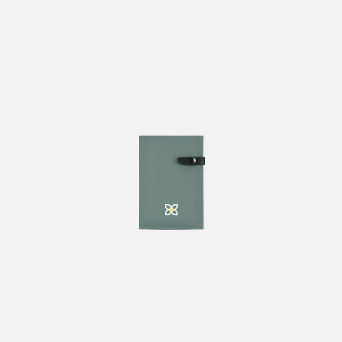 A Sherpani Osaka Lichen Passport Holder, front view showing clasp on white background.  #color_lichen