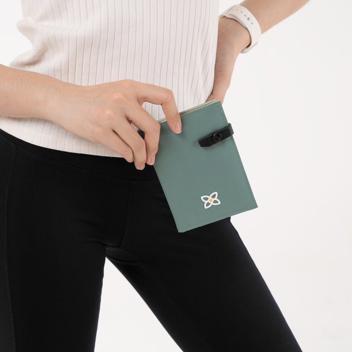 Person holding a Sherpani Osaka Lichen Passport Holder against white background.  #color_lichen