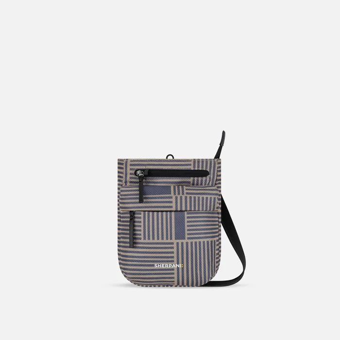 A Sherpani Prima Passport Anti-theft Travel Crossbody, front view showing lockable pocket and strap on white background. #color_passport-print