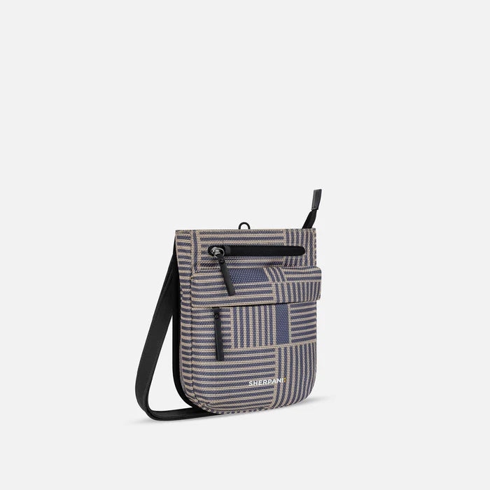 A Sherpani Prima Passport Anti-theft Travel Crossbody, 3/4 view showing lockable pocket and strap on white background. #color_passport-print