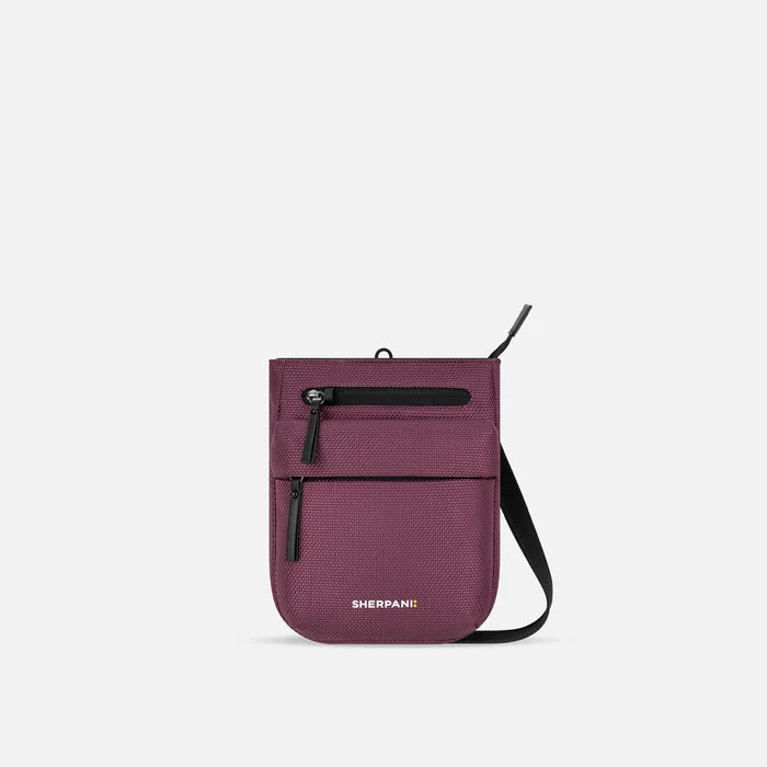 A Sherpani Prima Smoky Orchid Anti-theft Travel Crossbody, front view showing lockable pocket and strap on white background. #color_smoky-orchid-pink