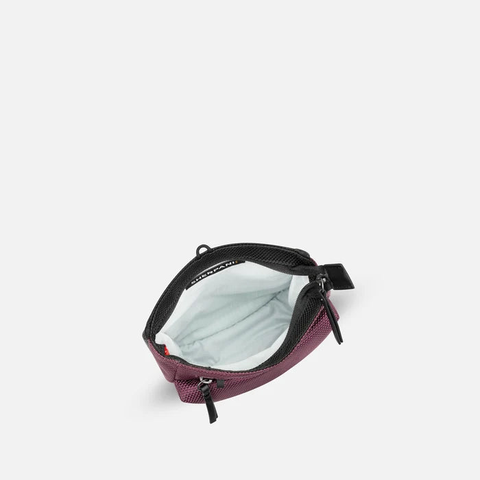 A Sherpani Prima Smoky Orchid Anti-theft Travel Crossbody, above view showing inside pocket on a white background. #color_smoky-orchid-pink