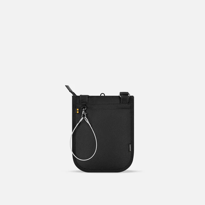A Sherpani Prima Smoky Orchid Anti-theft Travel Crossbody, back view showing black backside & chair lock on white backdrop. #color_smoky-orchid-pink