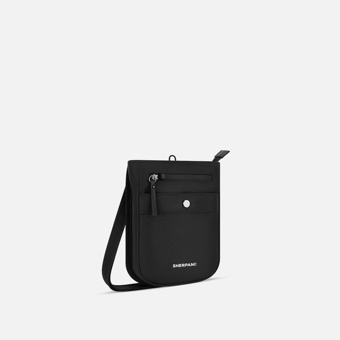 A Sherpani Prima Carbon Black Anti-theft Travel Crossbody, 3/4 view showing lockable pocket and strap on white background. #color_carbon-black
