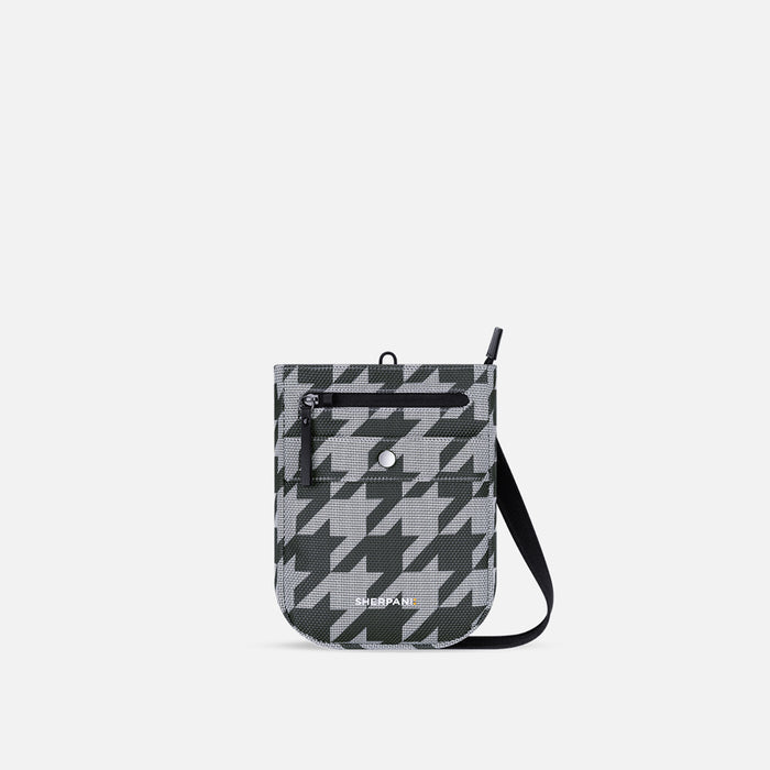 A Sherpani Prima Granite Grey Anti-theft Travel Crossbody, front view showing lockable pocket and strap on a white background. #color_houndstooth-print