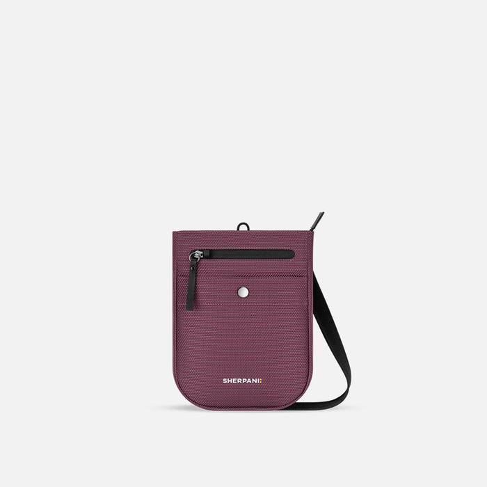 A Sherpani Prima Smoky Orchid Anti-theft Travel Crossbody, front view showing lockable pocket and strap on a white background. #color_smoky-orchid-pink