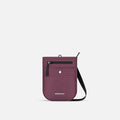 A Sherpani Prima Smoky Orchid Anti-theft Travel Crossbody, front view showing lockable pocket and strap on a white background. #color_smoky-orchid-pink