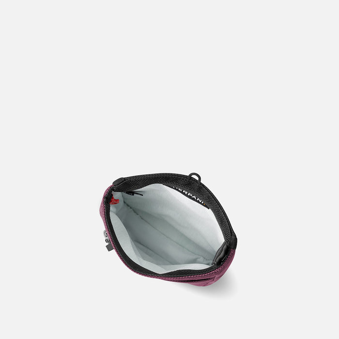 A Sherpani Prima Smoky Orchid Anti-theft Travel Crossbody, above view showing inside pocket on a white background.  #color_smoky-orchid-pink