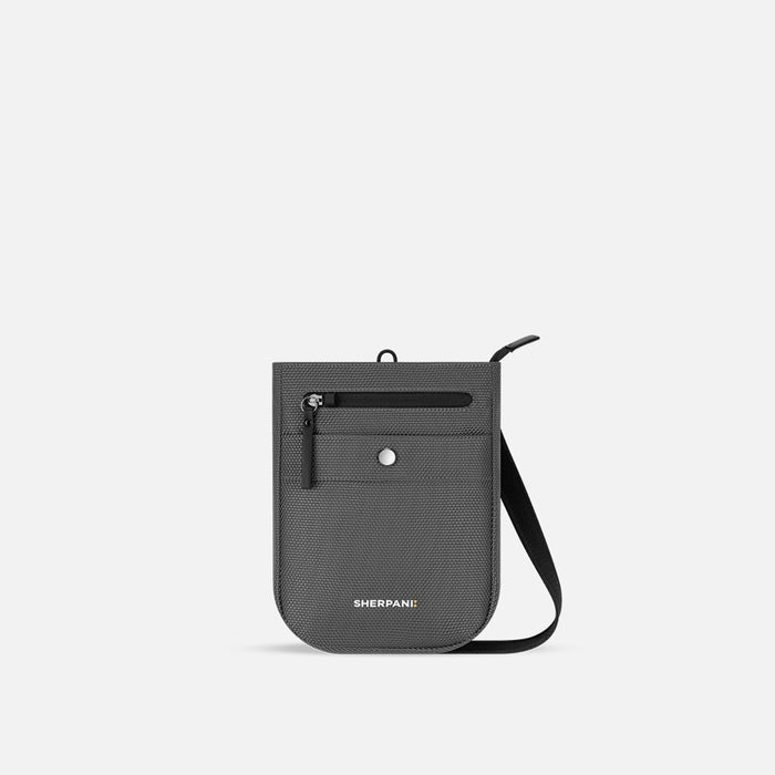 A Sherpani Prima Granite Grey Anti-theft Travel Crossbody, front view showing lockable pocket and strap on a white background. #color_granite-grey