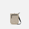 A Sherpani Prima Straw Beige Anti-theft Travel Crossbody, front view showing lockable pocket and strap on a white background. #color_straw-beige