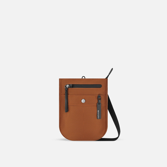 A Sherpani Prima Morocco Travel Crossbody, front view showing lockable pocket and strap against white background. #color_morocco