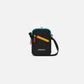 A Sherpani Rogue Chromatic Black Mini Crossbody, front view showing lockable pocket & strap on white backdrop.   #color_chromatic-black
