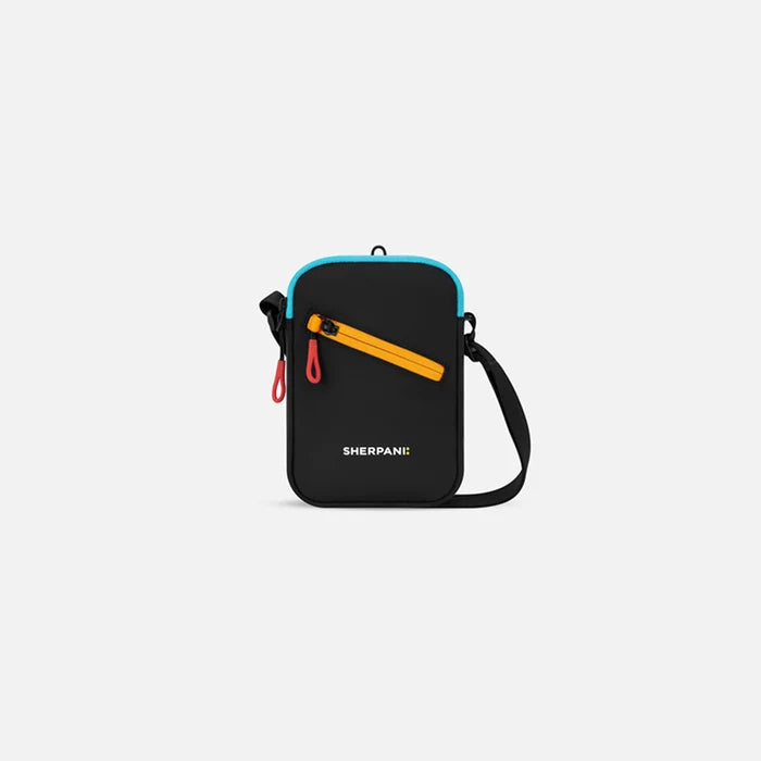 A Sherpani Rogue Chromatic Black Mini Crossbody, front view showing lockable pocket & strap on white backdrop.   #color_chromatic-black