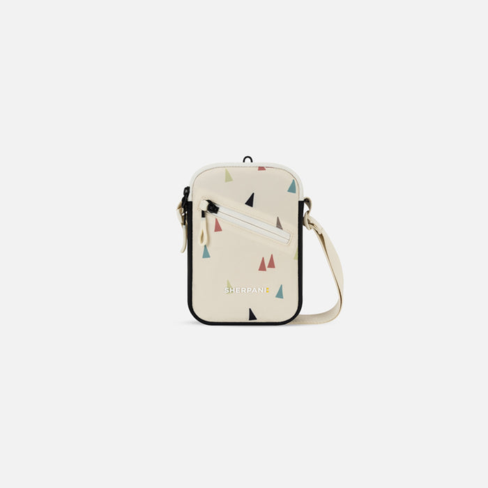 A Sherpani Rogue Terrazzo Print Mini Crossbody, front view showing lockable pocket & strap on white backdrop. #color_terrazzo-print
