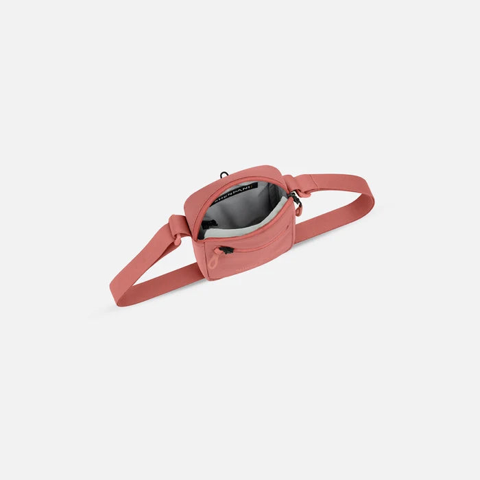 Sherpani Rogue Desert Pink Mini Crossbody, above view showing inside of main zipper pocket on white background.   #color_desert-pink
