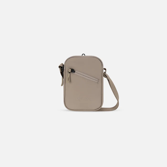 A Sherpani Rogue Dune Mini Crossbody, front view showing adjustable strap and main zipper pocket on white background.  #color_dune-tan