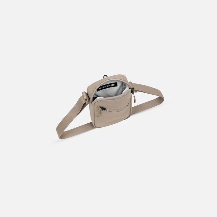 Sherpani Rogue Dune Mini Crossbody, above view showing inside of main zipper pocket on white background.   #color_dune-tan