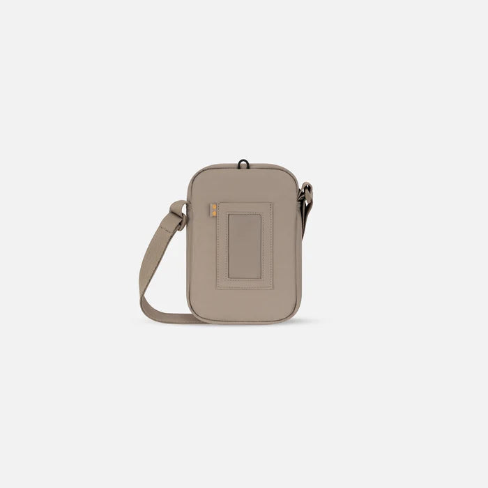 Sherpani Rogue Dune Mini Crossbody, back view showing back pocket on white background.    #color_dune-tan