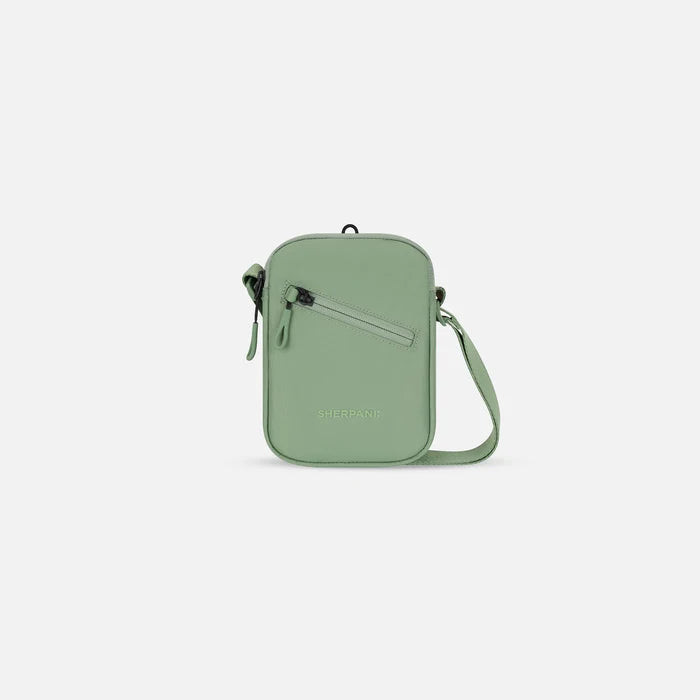 A Sherpani Rogue Olivine Mini Crossbody, front view showing lockable pocket & strap on white backdrop.  #color_olivine-green
