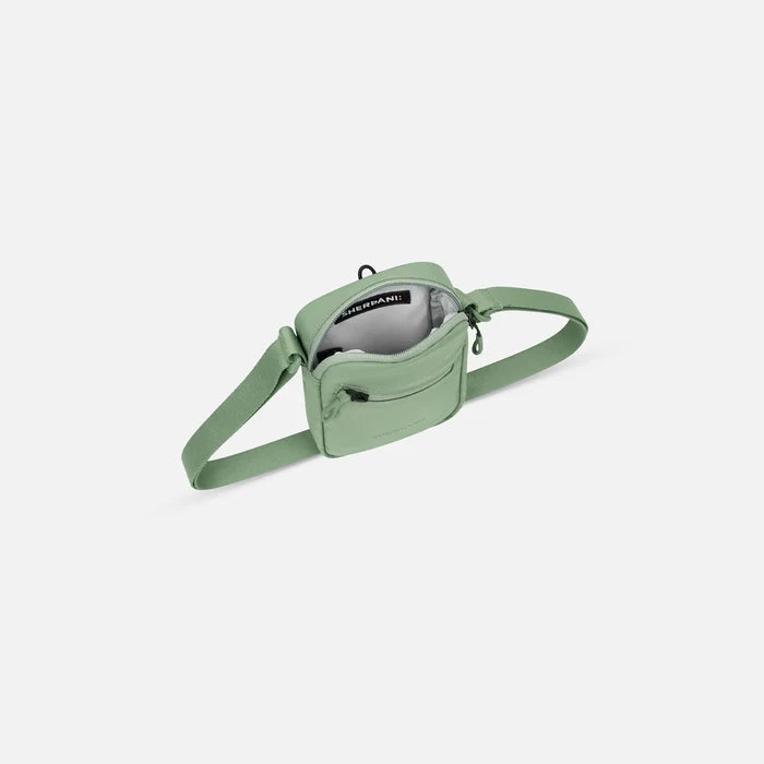 Sherpani Rogue Olivine Mini Crossbody, above view showing inside of main zipper pocket on white background.  #color_olivine-green