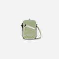 A Sherpani Rogue Palm Green Mini Crossbody, front view showing lockable pocket & strap on white backdrop. #color_palm-green