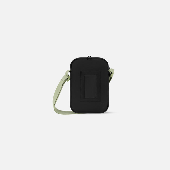 A Sherpani Rogue Palm Green Mini Crossbody, back view showing card holder & strap on white backdrop. #color_palm-green