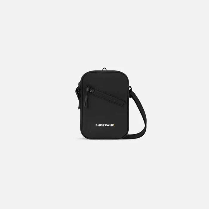 A Sherpani Rogue Raven Black Mini Crossbody, front view showing lockable pocket & strap on white backdrop.  #color_raven-black