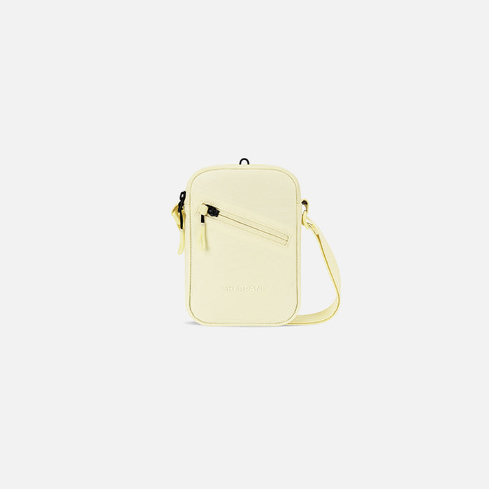 A Sherpani Rogue Sol Yellow Mini Crossbody, front view showing lockable pocket & strap on white backdrop. #color_sol-yellow