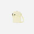 A Sherpani Rogue Sol Yellow Mini Crossbody, front view showing lockable pocket & strap on white backdrop. #color_sol-yellow