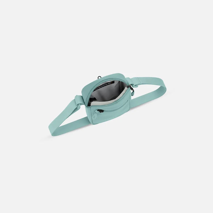 Sherpani Rogue Surf Blue Mini Crossbody, above view showing inside of main zipper pocket on white background.  #color_surf-blue