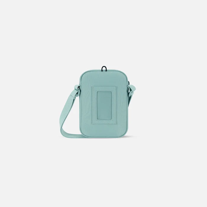 Sherpani Rogue Surf Blue Mini Crossbody, back view showing back pocket on white background. #color_surf-blue