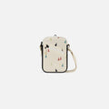 A Sherpani Rogue Terrazzo Print Mini Crossbody, front view showing lockable pocket & strap on white backdrop. #color_terrazzo-print