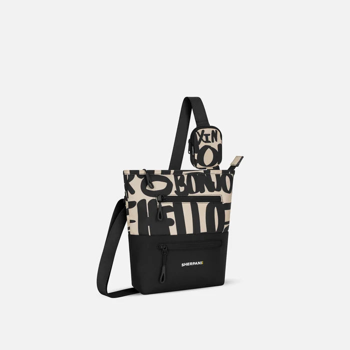 A Sherpani Ciao Crossbody Bag, 3/4 view showing front lockable zipper pockets and the pouch attached to the strap. #color_ciao-print
