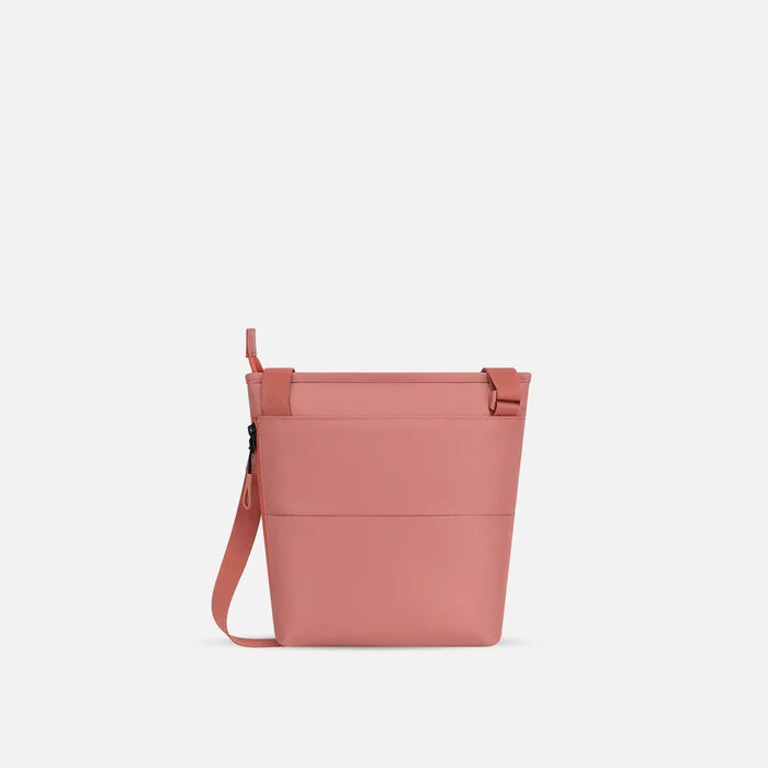 A Sherpani Sadie Desert Crossbody Bag, back view showing the side pocket.  #color_desert-pink