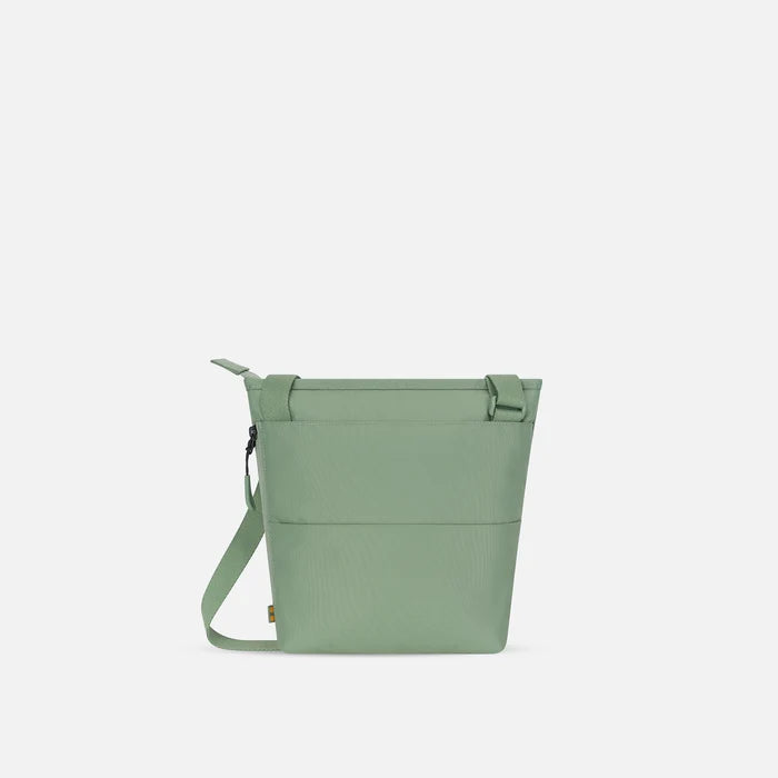 A Sherpani Sadie Olivine Crossbody Bag, back view showing the side pocket.  #color_olivine-green