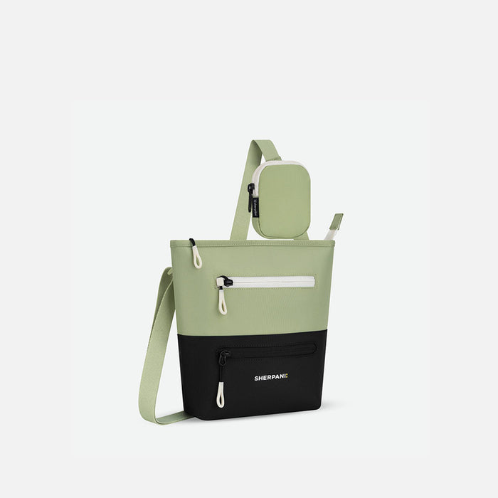 A Sherpani Sadie Palm Green Crossbody Bag, 3/4 view showing lockable Pocket and strap pouch against white backdrop.   #color_palm-green