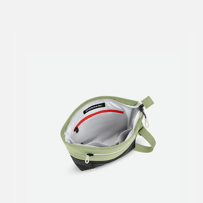 A Sherpani Sadie Palm Green Crossbody Bag, above view showing inside main pocket against white backdrop.   #color_palm-green