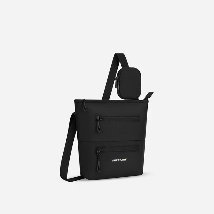 A Sherpani Raven Black Crossbody Bag, 3/4 view showing front lockable zipper pockets and the pouch attached to the strap. #color_raven-black