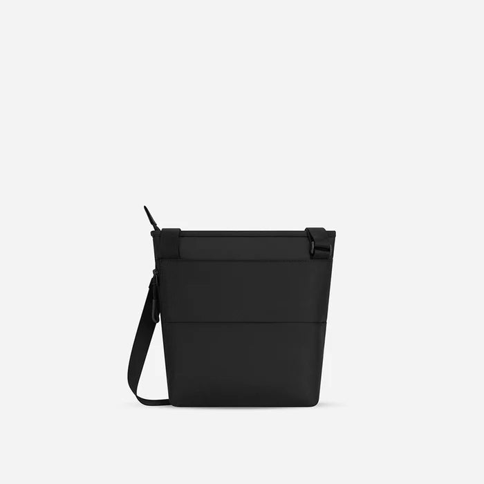 A Sherpani Sadie Raven Black Crossbody Bag, back view showing the side pocket.  #color_raven-black