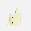 A Sherpani Sadie Sol Yellow Crossbody Bag, front view showing lockable Pocket & strap pouch against white backdrop. #color_sol-yellow