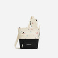 A Sherpani Sadie Terrazzo Print Crossbody Bag, front view showing lockable Pocket & strap pouch against white backdrop. #color_terrazzo-print