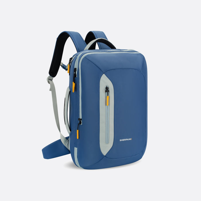 A Sherpani Santiago Seastone Travel Backpack, 3/4 view showing various lockable pockets and straps on white backdrop. #color_seastone