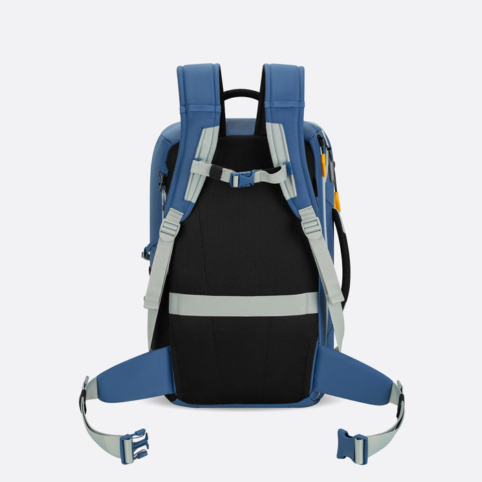 A Sherpani Santiago Seastone Travel Backpack, back view showing buckled shoulder & waist straps on white backdrop. #color_seastone